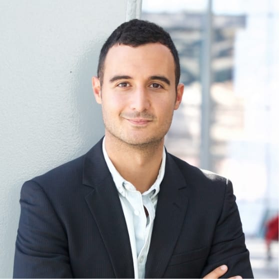 Professional man in a suit smiling confidently, representing client satisfaction with BrandMode's digital marketing services.