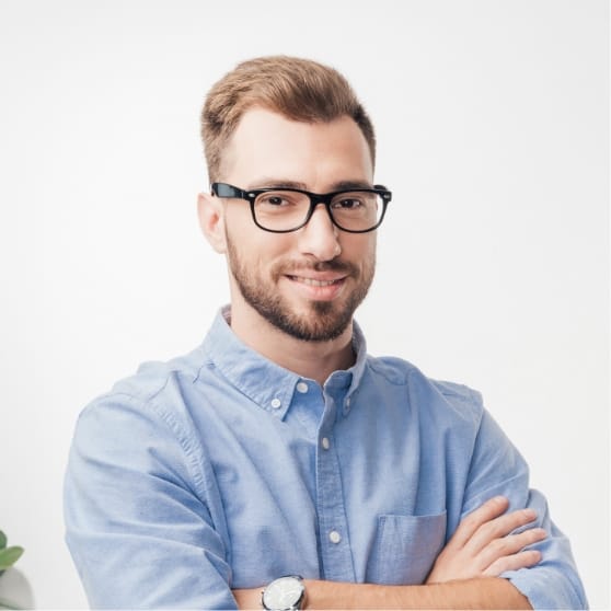 Smiling man in a blue shirt and glasses, showcasing BrandMode's successful client relationships and digital marketing expertise.